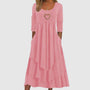Rosa Damenkleid mit Herzanhänger, dreiviertel Ärmel, Stufenrock, elegantes Design.