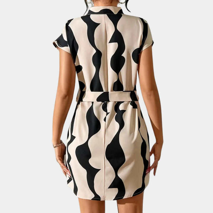 Damenkleid schwarz-weiß, abstraktes Muster, kurzärmelig, Gürtel, modisch, elegant.