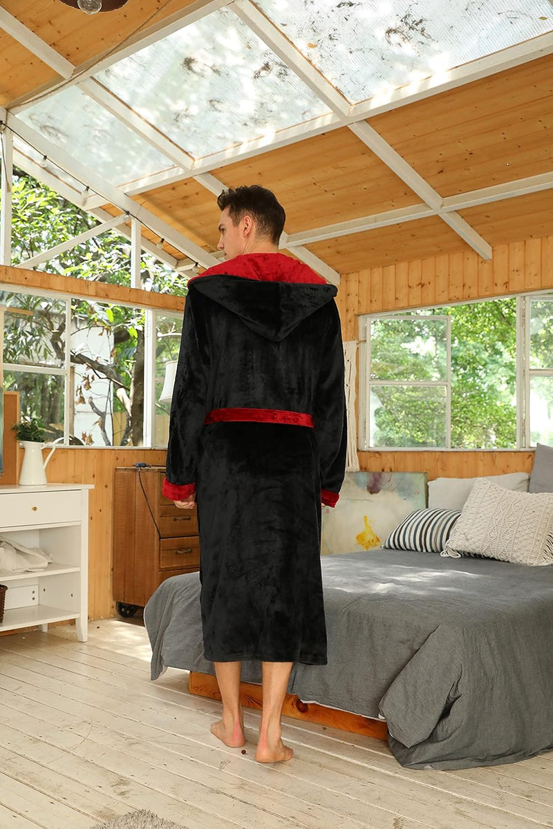 Rückansicht des schwarzen Bademantels mit roter Kapuzeninnenseite und rotem Gürtel in einem Holzraum 24