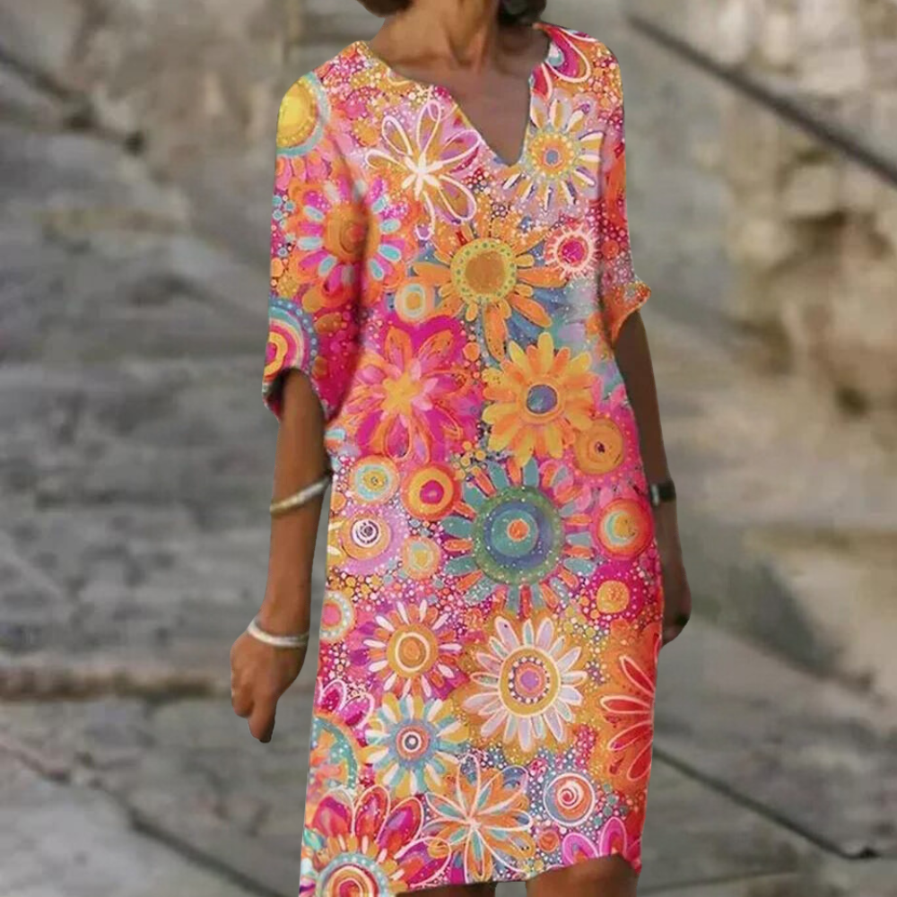 Frau in buntem, geblümtem Sommerkleid auf Treppe, modisches Design, Freizeitkleidung.