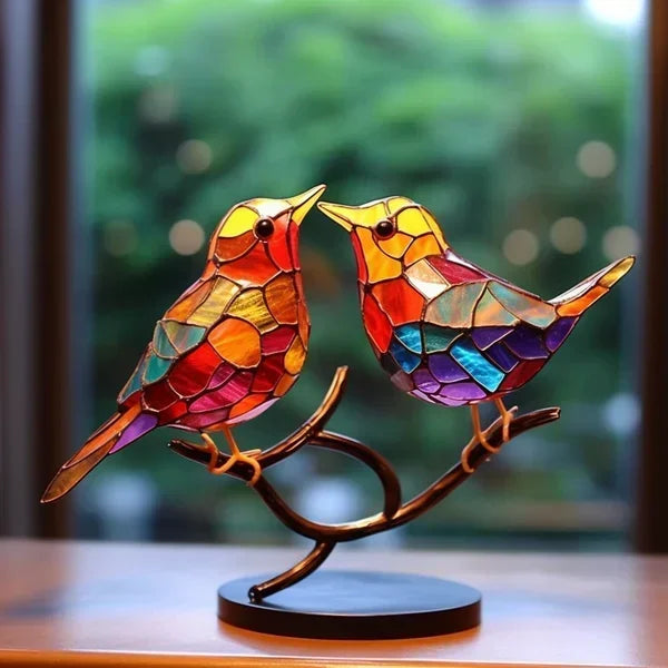Zwei einander zugewandte Vögel in Orange, Rot und Violett auf einem geschwungenen Zweig mit schwarzer Standfläche 4